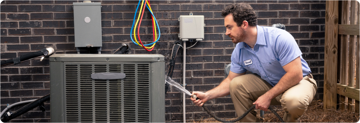 technician cleaning AC