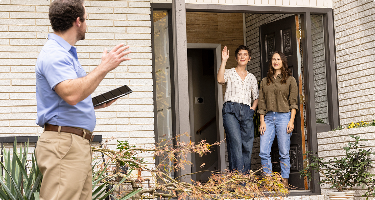 Technician waving to homeowners